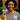 Woman holding an 'I Voted' sticker outdoors